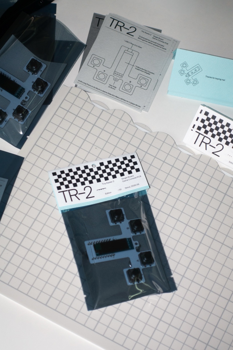 A TR-2 board bagged with its header card on a cutting mat