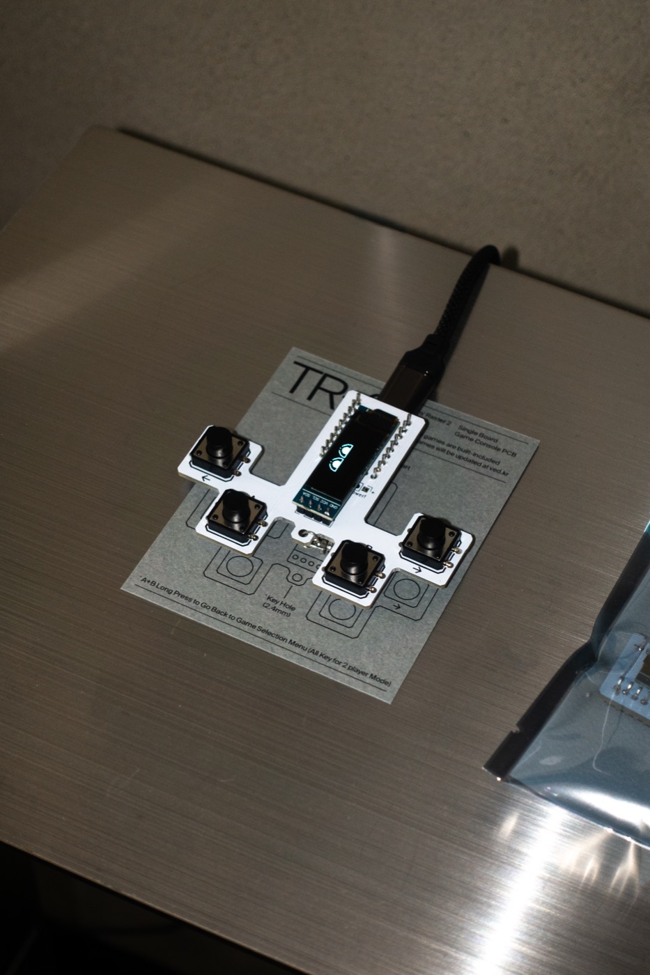A TR-2 board plugged in and running on a shop counter